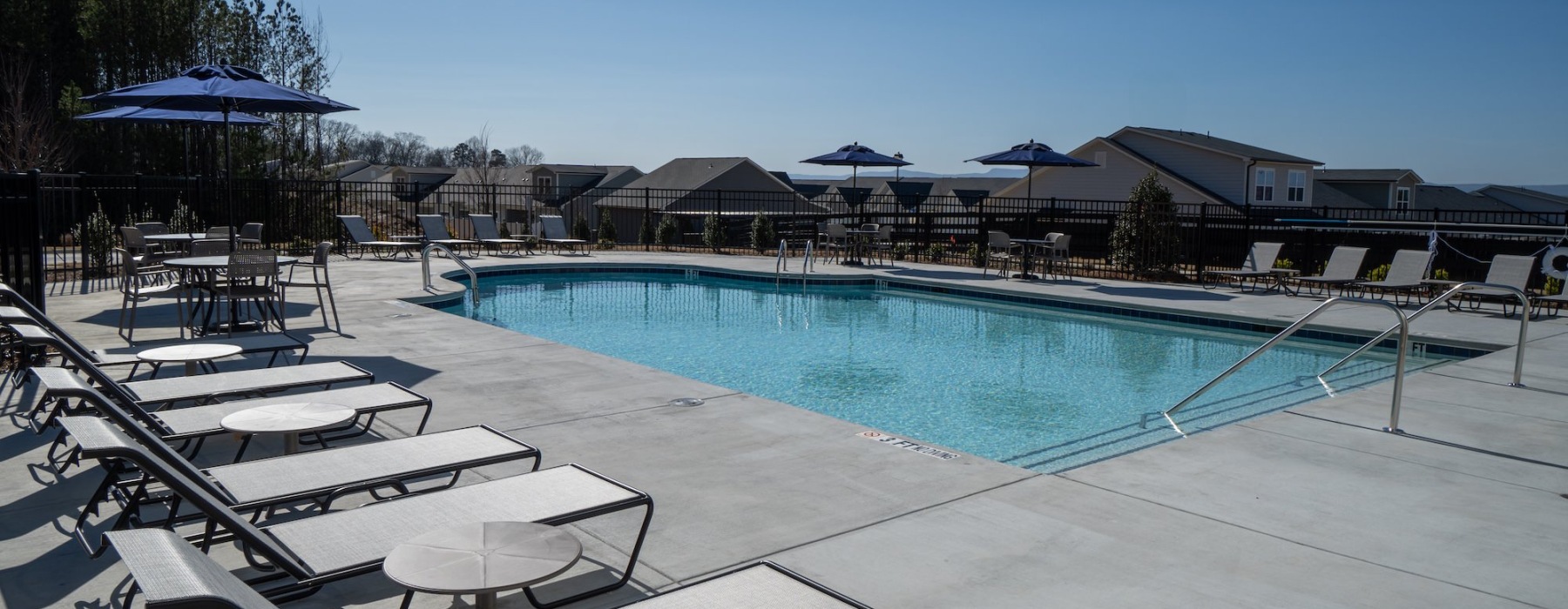Resort-style swimming pool with lounge seating